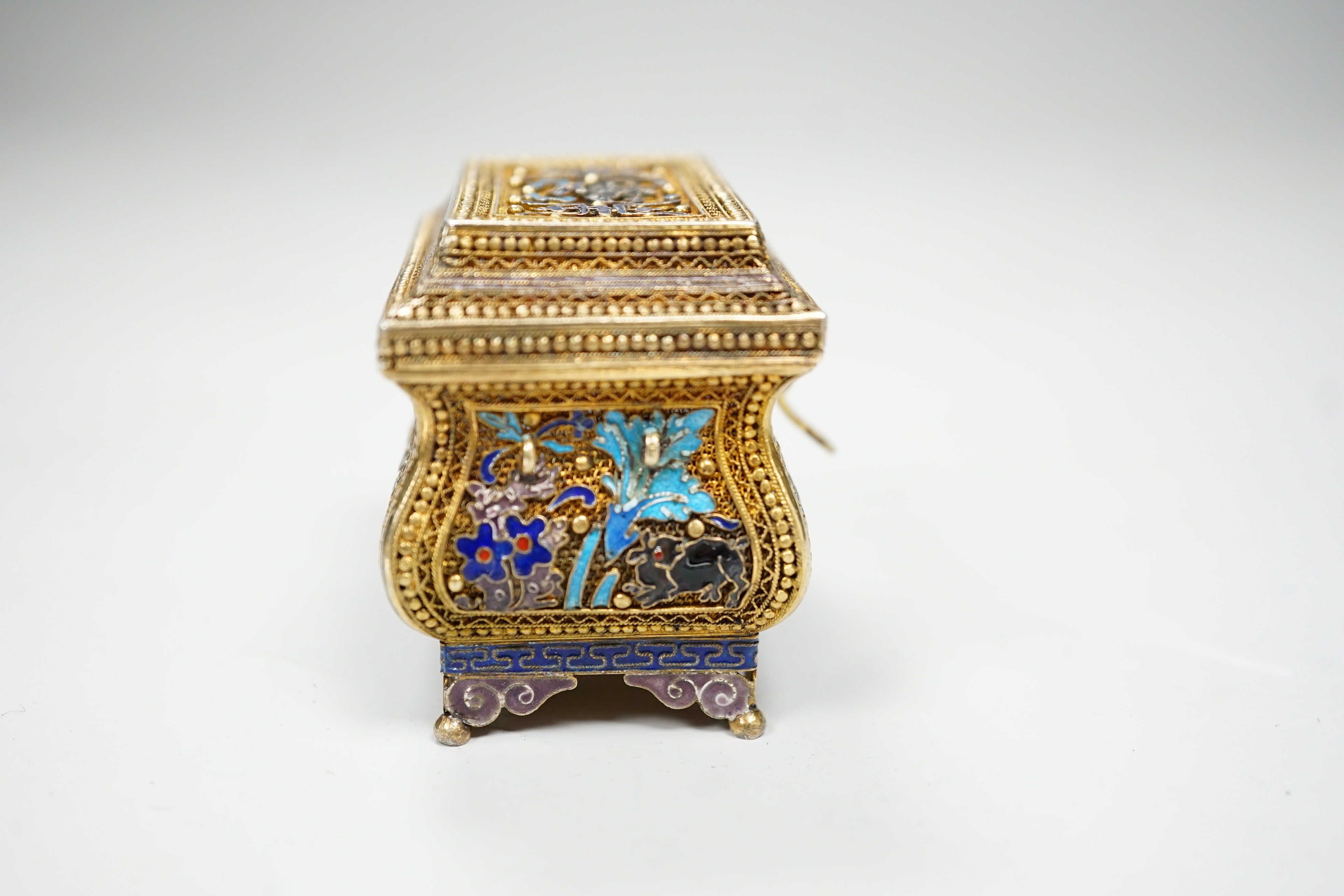 A Chinese gilded filigree white metal and enamelled trinket box, stamped 'silver', width 63mm, gross weight 76 grams.